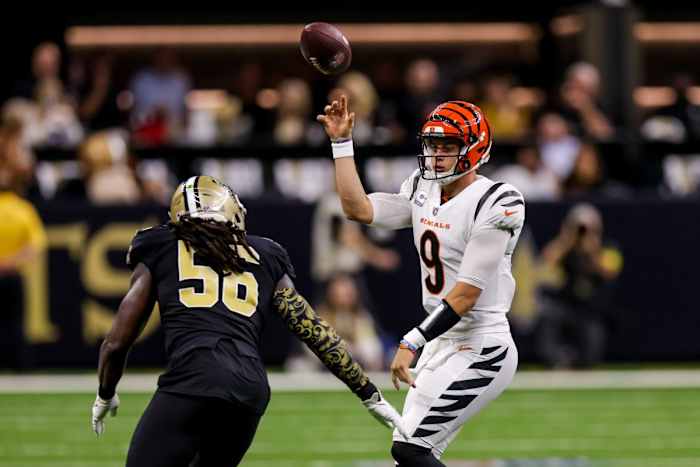 Cincinnati Bengals quarterback Joe Burrow (9) throws the ball away before being sacked by New Orleans Saints linebacker Demario Davis (56). Mandatory Credit: Stephen Lew-USA TODAY Sports